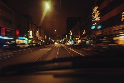 Illuminated road in city at night