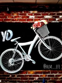 Digital composite image of bicycle on wall