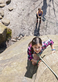 Teenage girl climbing at harrisons rock close to tunbridge wells