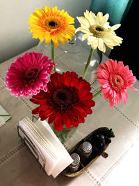 High angle view of various flowers in vase on table