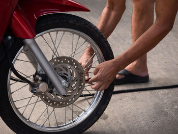 Low section of man with bicycle on street