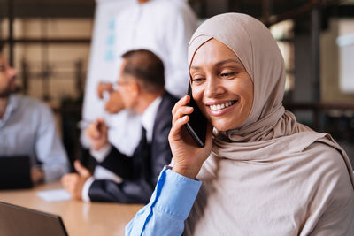 Portrait of young woman using mobile phone