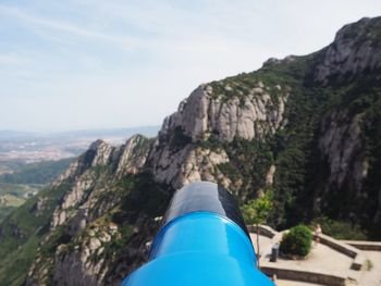 Scenic view of mountains against blue sky