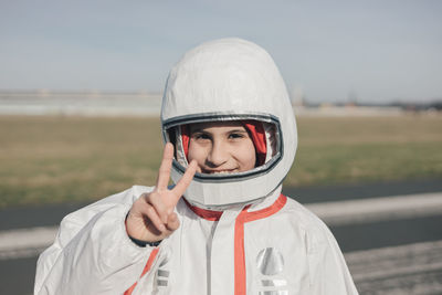 Portrait of smiling girl in astronaut costume, empowered girl concept, international women's day