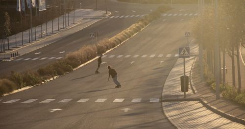 People skating on road