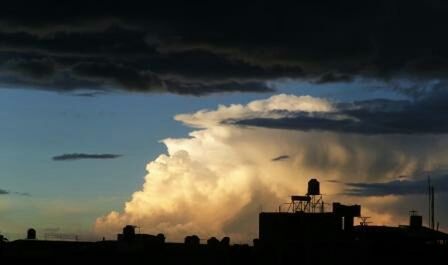 Silhouette of building against cloudy sky