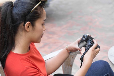 Midsection of woman photographing with mobile phone