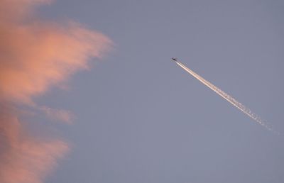 Low angle view of airplane flying against sky
