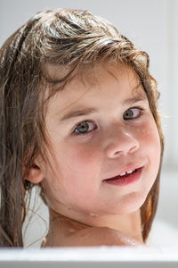 Close-up portrait of cute girl in bathroom