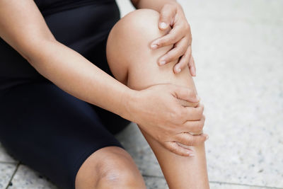 Low section of woman sitting on floor