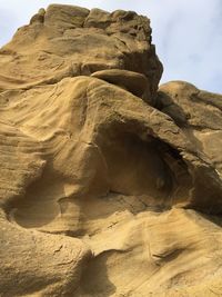 Low angle view of rock formations against sky