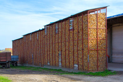 Rusty metallic structure on land against sky