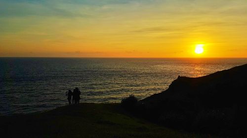 Scenic view of sea against orange sky