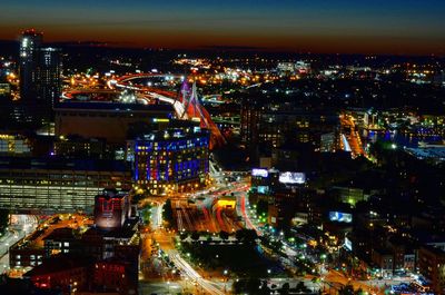Aerial view of city lit up at night