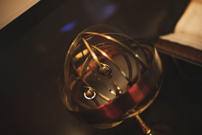 Close-up of illuminated lamp on table