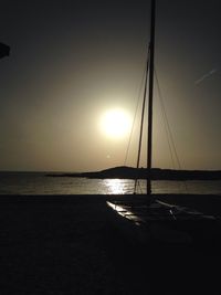 Boats in sea at sunset