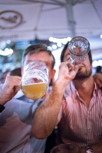 Close-up of man drinking glasses