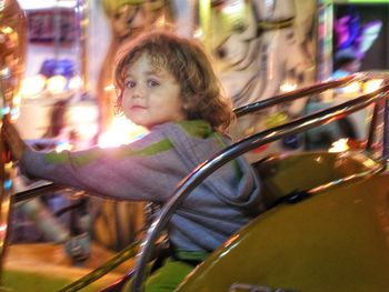 Close-up portrait of boy at amusement park