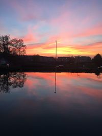 Scenic view of lake against orange sky