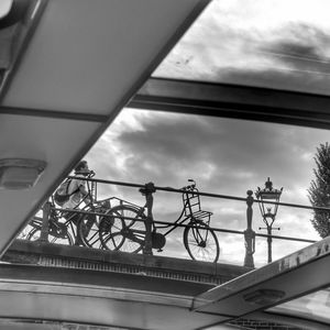 Low angle view of bicycle bridge against sky in city