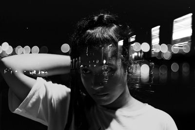 Double exposure image of woman and illuminated train at night