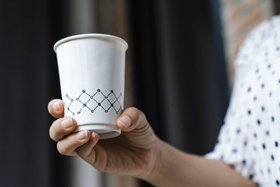 Close-up of woman holding coffee cup