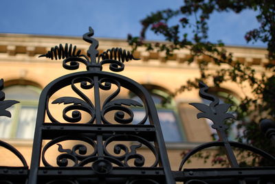 Close-up of metal gate against building