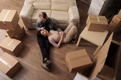 Low section of woman with cardboard box