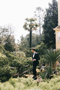 Side view of young man standing on land