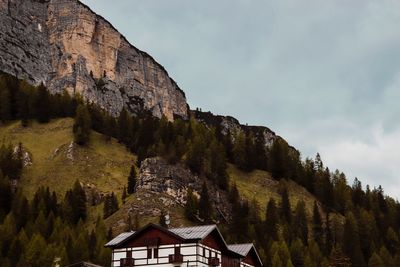 Low angle view of building and mountains against sky
