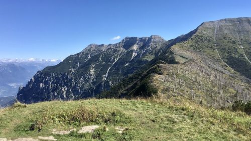 Scenic view of mountains against clear blue sky