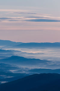 Scenic view of silhouette mountains against sky during sunset