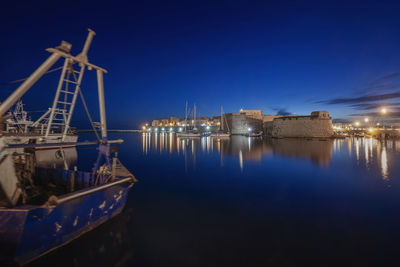 Sailboats in river against sky at night