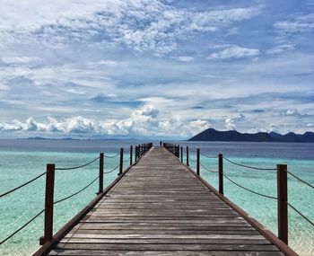 Pier over sea against sky