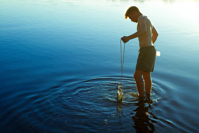 Full length of man standing in water