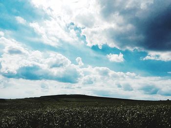 Scenic view of landscape against cloudy sky
