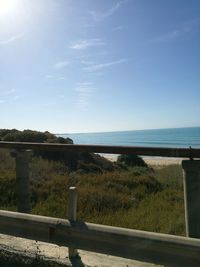 Scenic view of beach against cloudy sky