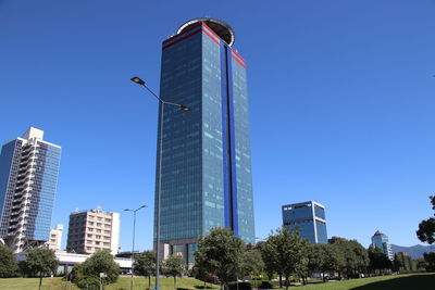 Low angle view of buildings against clear blue sky