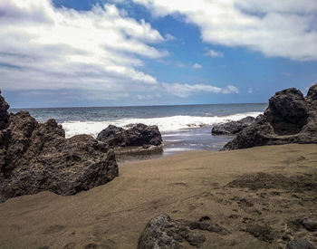 Scenic view of sea against cloudy sky