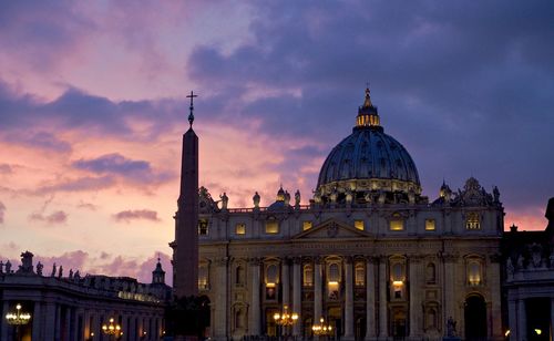 Low angle view of st peter basilica against sky during sunset