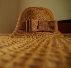 Close-up of straw hat on table