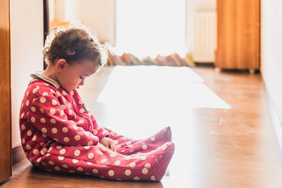 Girl sitting on floor at home