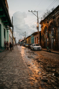 Street amidst buildings in city against sky