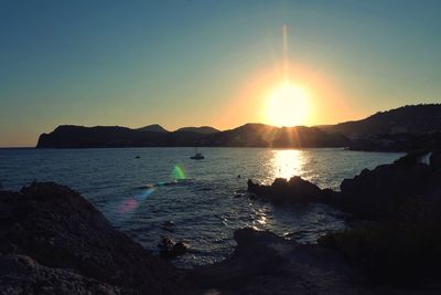 Scenic view of sea against clear sky during sunset