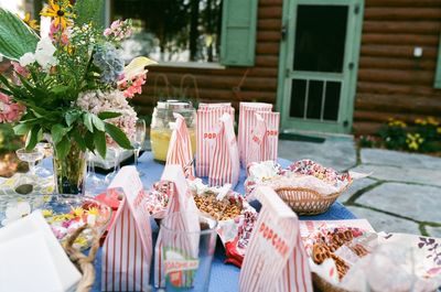 Popcorn packets on table against house