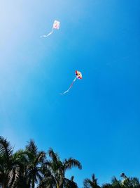 Low angle view of parachute against sky