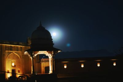 Illuminated building against sky at night