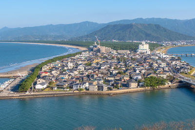 Aerial view of city by sea