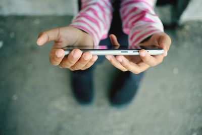 Close-up of hands holding mobile phone