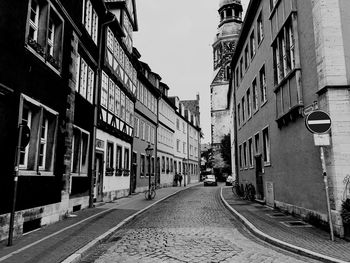 Empty alley amidst buildings in city